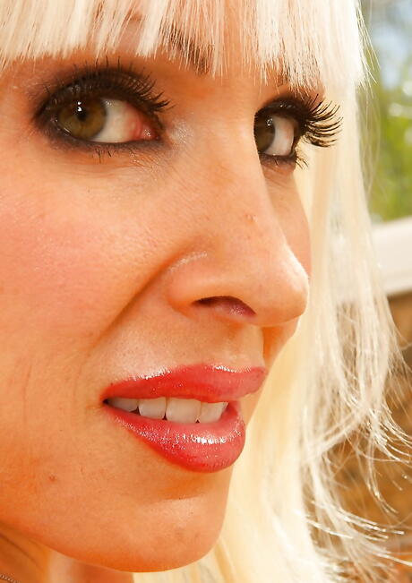 Seductive blonde milf Jade in panties exposing big boobies and ass 